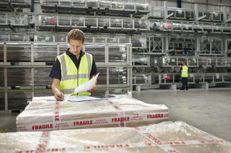 Warehouse worker checking order in engineering warehouse
